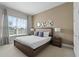 Well-lit bedroom with a queen bed and large window at 7540 Sunville Ave, Kissimmee, FL 34747