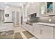 Modern kitchen with white cabinets and gray tile backsplash at 1010 N Pennsylvania Ave, Winter Park, FL 32789