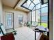 Relaxing sunroom with screened enclosure and seating at 14650 Sweet Acacia Dr, Orlando, FL 32828