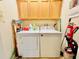 Laundry room with washer, dryer, and cabinets at 14650 Sweet Acacia Dr, Orlando, FL 32828
