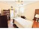 Comfortable bedroom with a bed, chair, and bookcase at 14650 Sweet Acacia Dr, Orlando, FL 32828