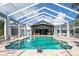 Enclosed pool with a view of the house and beautiful landscaping at 17017 Marsh Rd, Winter Garden, FL 34787