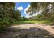 Expansive grassy area surrounded by lush trees at 17017 Marsh Rd, Winter Garden, FL 34787