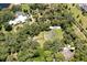 Aerial view of property showing pond, cottage, and trees at 17017 Marsh Rd, Winter Garden, FL 34787