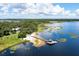An aerial view showcasing a waterfront property with a dock and lake access at 17017 Marsh Rd, Winter Garden, FL 34787