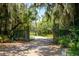 Ornate entrance gate leading to a paved driveway at 17017 Marsh Rd, Winter Garden, FL 34787