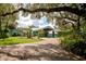 Blue house with covered entry and lush landscaping at 17017 Marsh Rd, Winter Garden, FL 34787