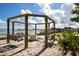 Gazebo with swings overlooking a calm lakefront at 17017 Marsh Rd, Winter Garden, FL 34787