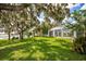 Expansive backyard with lush lawn and mature oak trees at 17017 Marsh Rd, Winter Garden, FL 34787