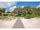 Boardwalk path leading to a waterfront home with swings and fire pit at 17017 Marsh Rd, Winter Garden, FL 34787