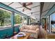 Long sunroom with ample seating and views of the backyard at 17017 Marsh Rd, Winter Garden, FL 34787