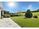 Landscaped backyard with lush lawn and spacious patio at 171 Silver Maple Rd, Groveland, FL 34736