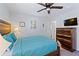 Bedroom with wooden bed frame and teal bedding at 2601 Isla Vista Ct, Kissimmee, FL 34747