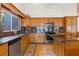 Spacious kitchen featuring granite countertops, stainless steel appliances, and wooden cabinets at 2982 Lake Woodward Dr, Eustis, FL 32726