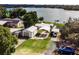 Aerial view of a house near the lake with a carport and private dock at 325 Lakefront Ct, Eustis, FL 32726