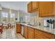 Kitchen features granite counters, wood cabinets, and a breakfast nook at 501 Mirasol Cir # 213, Celebration, FL 34747