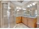 Large bathroom with double sinks, shower, and granite countertop at 501 Mirasol Cir # 213, Celebration, FL 34747