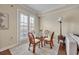 Bright dining area with glass table and wicker chairs, adjacent to kitchen at 501 Mirasol Cir # 213, Celebration, FL 34747