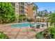 Community pool with lounge chairs and seating area at 501 Mirasol Cir # 213, Celebration, FL 34747