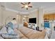 Open living room with sectional sofa and view of kitchen at 501 Mirasol Cir # 213, Celebration, FL 34747