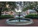 Community fountain with benches and brick path at 501 Mirasol Cir # 213, Celebration, FL 34747