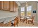 Bright breakfast nook with granite countertop and wicker chairs at 501 Mirasol Cir # 213, Celebration, FL 34747