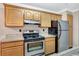 Efficient kitchen featuring wood cabinets, granite countertops, and stainless steel appliances at 623 Dory Ln # 308, Altamonte Springs, FL 32714