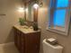 Clean bathroom with wood vanity, updated fixtures, and large mirror at 906 Red Oak Ct, Winter Springs, FL 32708