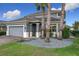 Two-story house with gray siding, landscaping, and a paved driveway at 987 Nathan Ridge Rd, Clermont, FL 34715