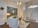 Bright living room featuring a neutral color palette, comfortable seating, and decorative wall art at 1102 Golf Course Pkwy, Davenport, FL 33837