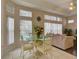 Casual dining area with a glass-top table and chairs, adjacent to the kitchen at 1102 Golf Course Pkwy, Davenport, FL 33837