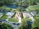 Community overview featuring homes with solar panels near a lake at 1102 Golf Course Pkwy, Davenport, FL 33837