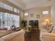 Relaxing Gathering room with ample natural light, comfortable seating, and a large TV at 1102 Golf Course Pkwy, Davenport, FL 33837