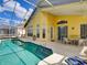Inviting pool area with patio furniture and a screened enclosure at 1102 Golf Course Pkwy, Davenport, FL 33837