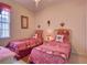 Guest bedroom with twin beds and red and white checkered bedding at 1102 Golf Course Pkwy, Davenport, FL 33837