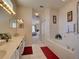Spacious Primary bathroom with double sinks, a large soaking tub, and a walk-in shower at 1102 Golf Course Pkwy, Davenport, FL 33837