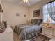 Bright bedroom with a queen-size bed and animal print bedding at 1102 Golf Course Pkwy, Davenport, FL 33837