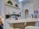 Well-equipped kitchen with white cabinetry, granite countertops, and a breakfast bar at 1102 Golf Course Pkwy, Davenport, FL 33837