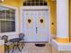Inviting front entrance with double doors, ornate door knockers, and a small patio set at 1102 Golf Course Pkwy, Davenport, FL 33837