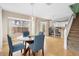 Bright dining area with glass table and blue chairs, near kitchen at 1820 Blaine Ter, Winter Park, FL 32792