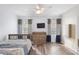 Bright bedroom with wood flooring, featuring a bed, dresser, and window with curtains at 1820 Blaine Ter, Winter Park, FL 32792