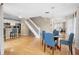 Bright dining area with glass table and blue chairs, hardwood floors, and view of kitchen at 1820 Blaine Ter, Winter Park, FL 32792