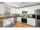 Modern kitchen with white cabinets, granite countertops, and stainless steel appliances at 1820 Blaine Ter, Winter Park, FL 32792