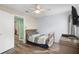 Bedroom with wood flooring, featuring a bed, dresser, and a view of a hallway at 1820 Blaine Ter, Winter Park, FL 32792