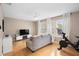 Comfortable living room with gray couch, flat-screen TV, and Peloton bike at 1820 Blaine Ter, Winter Park, FL 32792