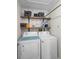 Functional laundry room with washer, dryer, and storage shelves at 1820 Blaine Ter, Winter Park, FL 32792