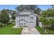 Two-story house with gray siding, a two-car garage, and a landscaped front yard at 1820 Blaine Ter, Winter Park, FL 32792
