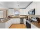 Modern kitchen with white cabinets, granite countertops, and stainless steel appliances at 1820 Blaine Ter, Winter Park, FL 32792