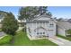 Two-story house with gray siding, a two-car garage, and a well-manicured lawn at 1820 Blaine Ter, Winter Park, FL 32792