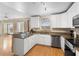 Modern kitchen with white cabinets, granite countertops, and stainless steel appliances at 1820 Blaine Ter, Winter Park, FL 32792